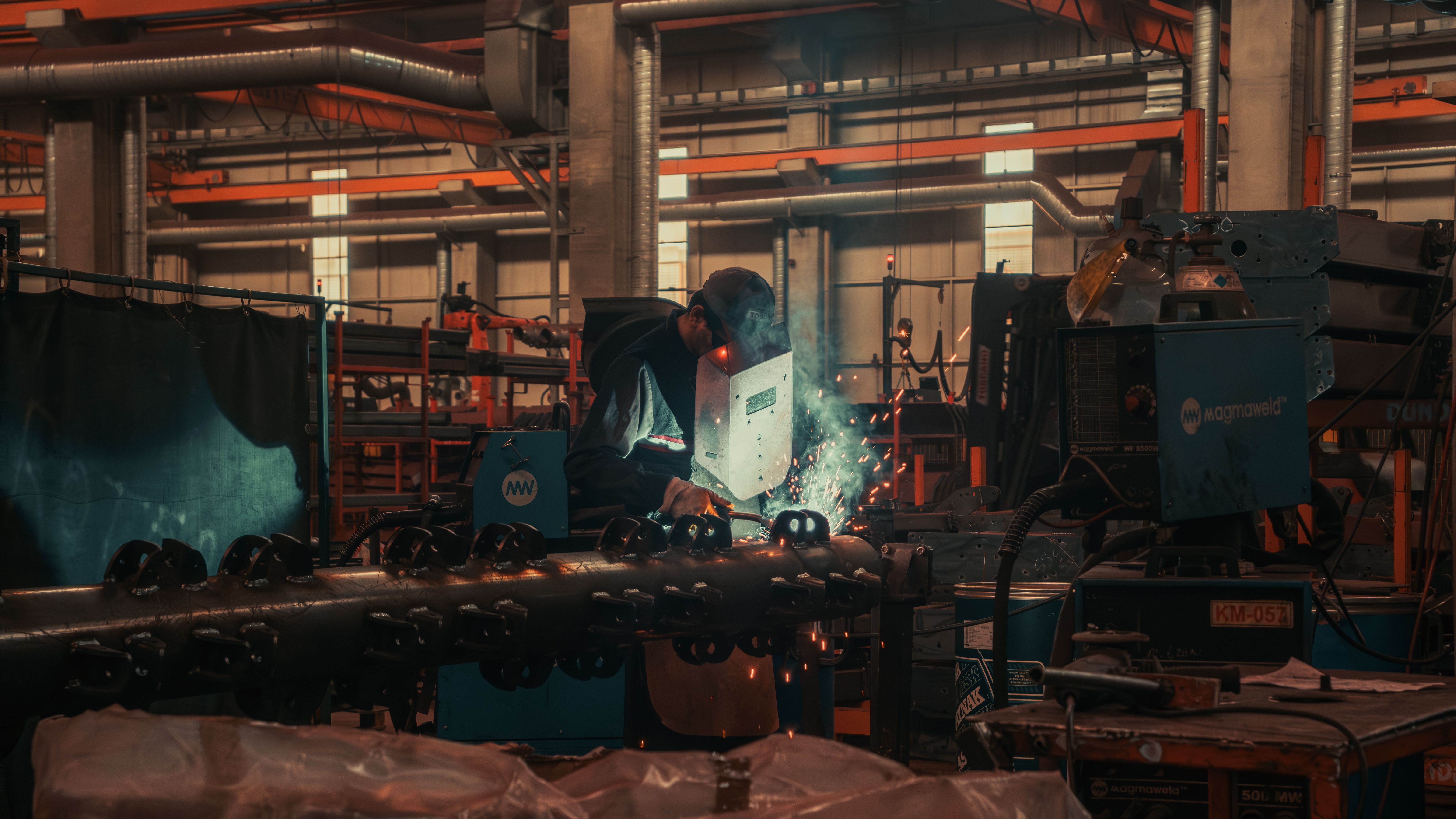 A welder at work on a factory floor