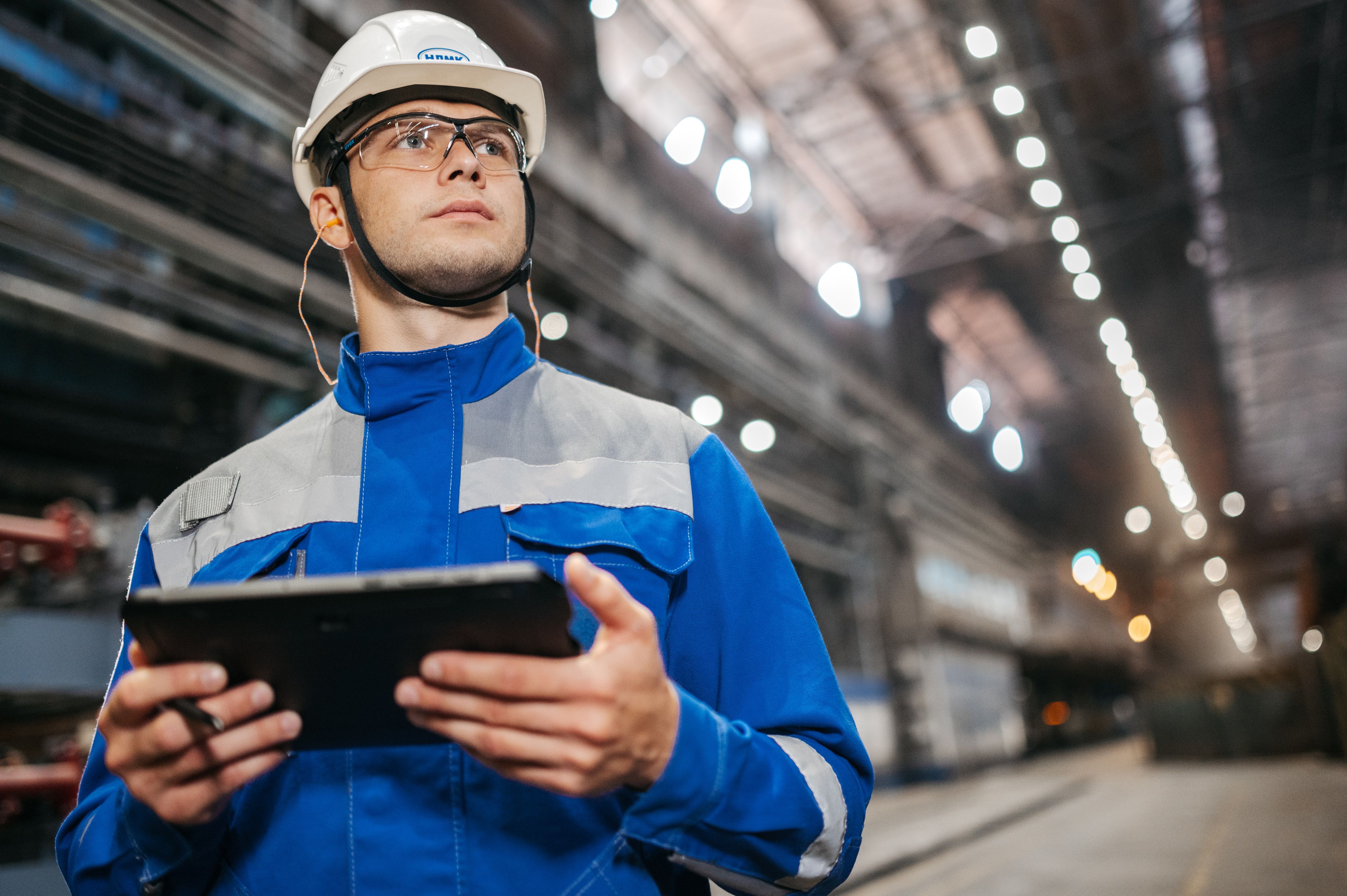 A worker using a tablet on the shop floor